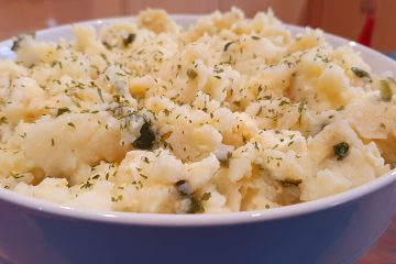 potato salad in a bowl garnish with dried parsley