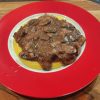creamy polenta with mushrooms & red wine gravy on a plate